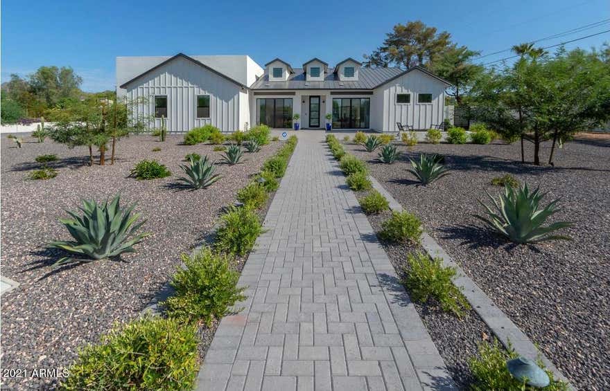Remarkable estate home with amazing views of Camelback Mountain. The home is a newer build (2019), modern home with high ceilings, wood floors, designer rest rooms, modern kitchen with 8 burner gas stove, multiple ovens, refrigerators, bar coolers, and more. The home is equipped with floor to ceiling patio doors, outside retreat and dining area and a sparkling modern pool. Close to A-rated schools, world class eateries, shopping and more. Perfect place to call home for the family with grit and grace!