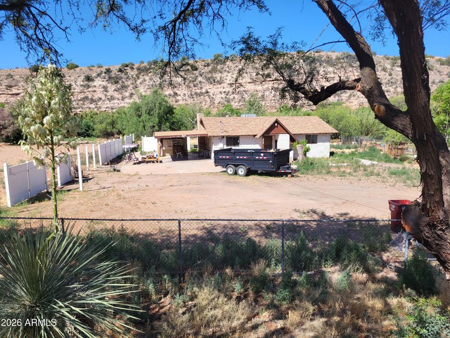 Enjoy over 3/4 of an acre with around 150' of Oak Creek frontage!  4 bedrooms and 2 bathrooms toward the end of a dead end road.  With some TLC, this home could become your dream home!  Two Parcels will be conveyed with the purchase.  Property has been owned by this family for around 55 years and during that time period, the home has never flooded.  Across the creek is a large vineyard, so you won't have to worry about homes being built that overlook your property!  Come claim your piece of Oak Creek!