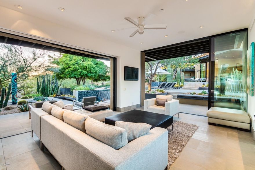WALLS OF GLASS open to Botanical Garden grounds with CAMELBACK MOUNTAIN VIEWS! Stunning modern architecture boasts dramatic high ceilings with expansive floor to ceiling vanishing glass walls bringing the outdoors inside.  Remodeled by Ethan & Sarah Wessel Tennen Studio/Tennen Construction this masterpiece boasts impeccable finishes and design.  4284 sq. ft. main residence features 3 bedrooms, 3.5 baths, family room & office.  1490 sq. ft. POOLSIDE CASITA offers living room, kitchenette, bedroom, bath and fitness center.  RESORT STYLE OUTDOOR SPACES offer perfect entertaining venues, private courtyards, HEATED POOL WITH WATERFALL & incredible lush landscaping. 300 BOTTLE GLASS WALL WINE ROOM, Poggenpohl cabinets, glass rock fireplaces & limestone floors are just a few of the many special features found in this hillside dream home. All bedrooms are ensuites.  Casita bath offers jetted tub & large steam shower.  Master bedroom bed, casita bed & dining room table and chairs were made for this property and will convey with the sale.  Seller is building a new home and would be willing to lease back.