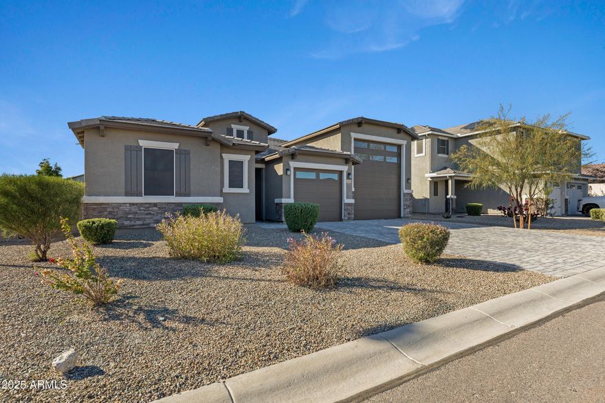 Spacious corner-lot home with no neighbors behind! Features include an oversized four-car RV garage, insulated with two split AC units, RV power hookup, and plumbed for future sink. Inside, enjoy a gourmet kitchen with double ovens, granite countertops, quartz farmhouse sink, and electric cooktop. The master suite offers direct laundry access and a spa-inspired bath with an extra-large rain shower. Living room boasts in-ceiling surround sound speakers. Whole-house water softener included. Exit your beautiful Double glass doors to your huge backyard where its a blank canvas ready for your dream design. Front of home has extended paver driveway which leads to your one-of-a-kind property!