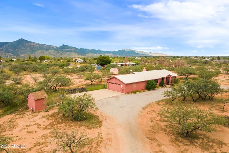 Welcome to your new desert retreat- a lovingly cared for, 2-bedroom, 2-bathroom ranch-style home built in 1995, on 4 acres of serene desert landscape. At the heart of the home, a spacious great room offers abundant natural light, fireplace and seamless flow. The split plan provides privacy, while the expansive windows showcase sweeping mountain views of Miller Peak. Upgrades include:(2024) exterior and interior paint, foam roof (10-yr warranty), hot water heater, and owned water softener. New (2023) HVAC, primary shower (2022), owned solar and a private well. Enjoy rural living, with room for horses or toys, less than 20 minutes from town. Experience the comfort, peace and beauty of the Sonoran Desert.
