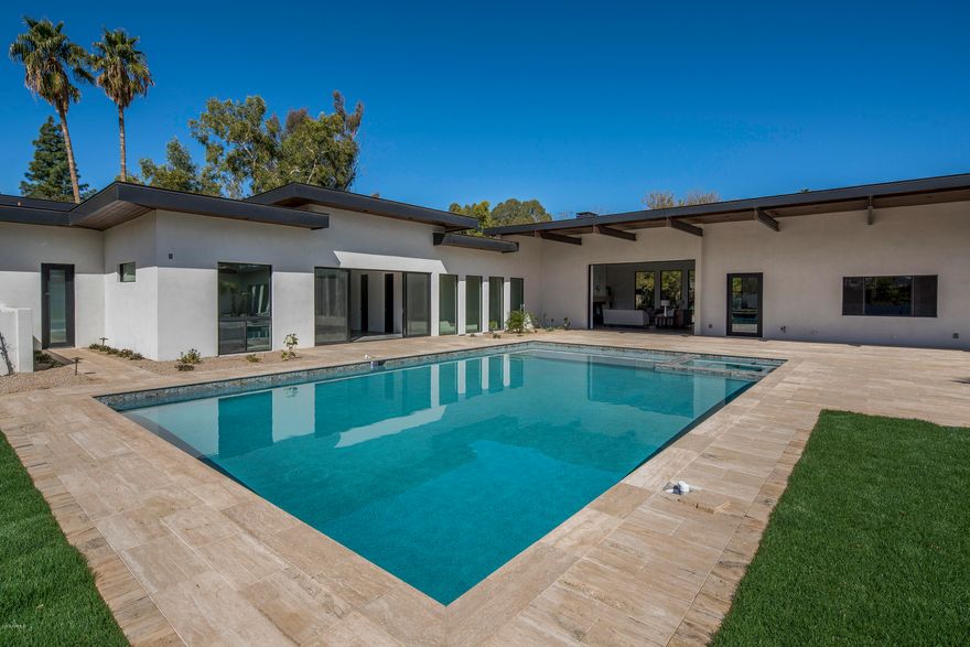 Just completed & pure perfection! This modern, contemporary estate is located in the heart of Paradise Valley. With a master suite, 4 guest bedrooms, 5 car garage, bonus room & stunning mountain views, what more could you ask for? The extensive master suite hosts a designer bathroom, two massive walk-in closets and two bonus rooms that would work perfectly as a gym & home office. Kitchen features an oversized quartz island, top of the line appliances and oversized wine refrigerator; perfect for entertaining. High quality finishes found throughout the home including porcelain tiles, custom cabinetry and top of the line light fixtures. The wall of telescoping doors in the family room make a seamless transition into the beautiful outdoor living space. This gorgeous estate will not last long!