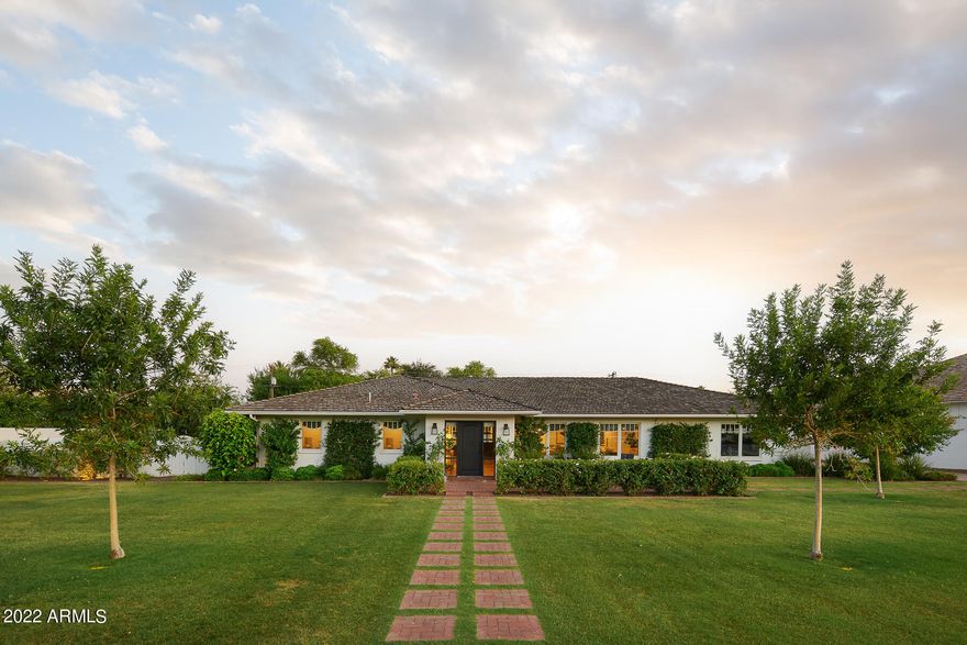 Warm and welcoming family home that is both stylish and comfortable! This beautiful ranch home was completely renovated in 2018, creating an open great room concept with soaring ceilings, loads of 8' doors and windows that bring in plenty of natural light and welcomes the outside in. This entertaining home features 4 bedrooms / 3.5 baths plus an office.  Using only the finest of finishes, this home boasts warm, wide planked, white oak flooring throughout, custom tile work and top of the line appliances and amenities. Detailed trim work throughout with custom crown, door casing and baseboards. Chef's kitchen includes custom cabinetry, Wolf and Sub Zero appliances, quartz countertops, a spacious island for additional seating and storage and beautiful custom plumbing and light fixtures. Generously sized primary suite features walls of windows and doors opening to the sizable yard and pool, custom Cle tile work in the primary shower and flooring, custom cabinetry, gracious soaking tub and custom built out primary closet.  Spare bedrooms are spacious with one bedroom being ensuite with a private patio overlooking a shady side yard orchard that features an orange and a lemon tree!  

All of this sits on more than half an acre of lush green lawn with sprawling Camelback Mountain views! Entertaining brick patios sweep the rear of the house and overlook the sparkling 30' long pool with baja step and custom patterned tile line. So much to enjoy about this wonderful home and plenty of room to add your own special touches!