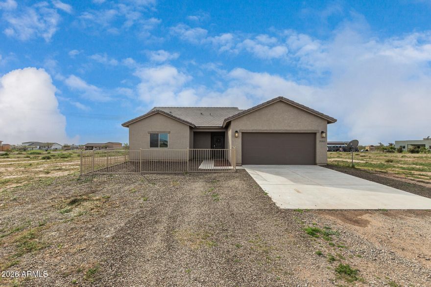 Don't miss this perfectly positioned home on over an acre of land with mountain views! The inviting 3-bedroom, 2-bath home offers 1,465 sq. ft. of thoughtfully designed living space. A modern aesthetic shines through with plank tile flooring and an open-concept layout ideal for both everyday living and entertaining. The bright kitchen is beautifully appointed with sleek granite countertops, stainless steel appliances, crisp white cabinetry, a convenient breakfast bar and a welcoming dining area. The split-plan primary suite provides a private retreat, complete with an en suite bath featuring a granite-topped vanity, custom-tiled shower  and spacious walk-in closet. Enjoy peaceful outdoor living on the relaxing covered patio with fenced backyard, complemented by a charming wrought-iron fenced courtyard in front of the home. With easy access to Grand Ave./Hwy 60, no HOA and all appliances included, this move-in-ready property offers comfort and convenience.