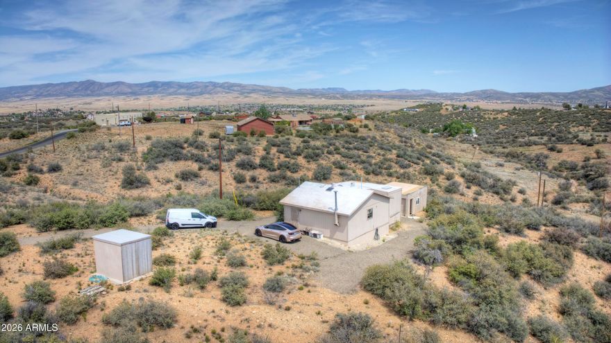 Rare opportunity to own 2.61 acres with panoramic Bradshaw Mountain views in Dewey! This property offers wide-open space, privacy, and endless potential. The 790 sq ft home (1 bed / 2 bath, built in 2006) features durable steel construction and a composition roof--ideal as a primary residence, weekend retreat, or rental.

The expansive acreage provides room for horses, RV parking, a workshop, or future expansion. With no HOA and no subdivision restrictions, you have the flexibility to create your ideal lifestyle. Enjoy peaceful rural living with stunning views and easy access to Hwy 69 and nearby Prescott Valley amenities.

Perfect for buyers seeking land, freedom, and long-term potential. Buyer to verify all utilities, zoning, and uses.