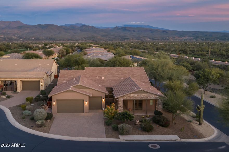 Tucked away on a quiet cul-de-sac in the sought-after Trilogy at Verde River Community, this thoughtfully designed home offers 3 bedrooms, each with a private ensuite, 3.5 baths, a den, and a dedicated office. The open great room features multi-slide doors and flows into a chef's kitchen with built-in stainless steel appliances, a large island, and a morning kitchen with additional cabinetry. The primary suite includes a custom closet and a spa-like bath with soaking tub, separate shower, dual sinks, and a dedicated vanity. Outside, enjoy a serene backyard with a peaceful water fountain, expansive covered patio built-in BBQ, and sweeping mountain views. The 3-car garage includes built-in cabinets, a workstation, and a water softener.  The amenities at Verde River are World Class with Tom Lehman inspired eighteen-hole Golf course, tennis courts,12  pickleball courts, and bocce ball, heated lap pool and Resort style swimming pool, hot tub, Afterburn fitness center, Helen's demonstration Kitchen for cooking classes and a 7.5 acre dog park. The community center has casual poolside dining at Eddy's Diner and gourmet dining at award-winning Needle Rock Kitchen and Tap, Alvea Spa with full-service Salon and Spa amenities, Art Loft and events center. Trilogy at Verde River is adjacent to the Tonto National Forest and is situated in the middle of miles and miles of hiking and biking trails.