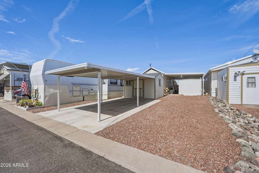 Looking for an RV lot in Florence AZ with utilities and workspace? This 30x42 lot at 110 E Mesquite in Caliente Casa De Sol is nicely landscaped and located on the sunny side of the street. The property features a Tuff Shed with workbench and electric, a covered carport, and is ready for RV setup with full hookups. This lot provides space for RV parking, storage, or workshop use within the community. This parcel must be sold together with the park model located at 116 E Mesquite Dr and cannot be purchased separately (see MLS 6998936). Located in Florence AZ 85132, within the active adult community of Caliente Casa De Sol. This RV lot in Florence AZ offers a well equipped additional parcel within the active adult community of Caliente Casa De Sol. Located at 110 E Mesquite, Florence AZ 85132, this 30x42 lot is nicely landscaped and positioned on the sunny side of the street, providing a bright and functional outdoor space.

The property includes a Tuff Shed workshop with built-in workbench and electric, offering a convenient space for tools, hobbies, or storage. A covered carport provides shaded parking, and the lot is ready for an RV setup with full hookups, making it ideal for RV owners or additional parking and storage needs within the community.

This parcel provides flexible use while remaining within the well maintained Caliente Casa De Sol neighborhood.

Important: This lot must be sold together with the park model located at 116 E Mesquite Dr and cannot be purchased separately. Both properties are included as part of the overall sale.

Residents of Caliente Casa De Sol enjoy community amenities including heated pools and spas, clubhouse, fitness center, pickleball courts, billiards room, library, and organized social activities that create an active lifestyle in Florence.
