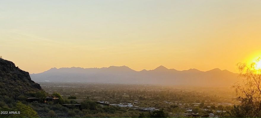 ONE OF A KIND, RARE +2 Acres elevated lot , capturing exceptional 40 mile views, including uniquely distinct city lights, in the prestigious and private guard gated community of La Place Du Sommet. This unique hillside view lot's building envelope has only 13.8% incline, with many features of a flat lot, resulting in substantial savings in construction costs, such as excavations and retaining walls. Noteworthy, another rare and sought-after feature, is that by midafternoon, during the hottest part of the day, your future home will be shaded, while fully capturing the majestic sunset skies and sweeping city and mountain views. This feature, makes a significant difference in comfort, energy savings and property value-added. Several, fact based collaborative and proactive meetings at site, with Paradise Valley City Staff (Zoning, Hillside & Engineering), followed up, with actual Architect and Civil Engineering designed options, for the building envelop, maximizing view and home layout and conforming to suggestions and guidance of the Paradise Valley City Staff, will result in substantial reduction in time, during the Official Plan Approval Process, a builder and owner's dream. Additional valuable information will be shared when visiting the lotThe current owner is committed and willing to accompany the future buyer in the valuable and necessary, smooth ownership transition optimization meetings with PV City Staff, to facilitate the continuation of support and accomplishment of the buyer's dream home. the
