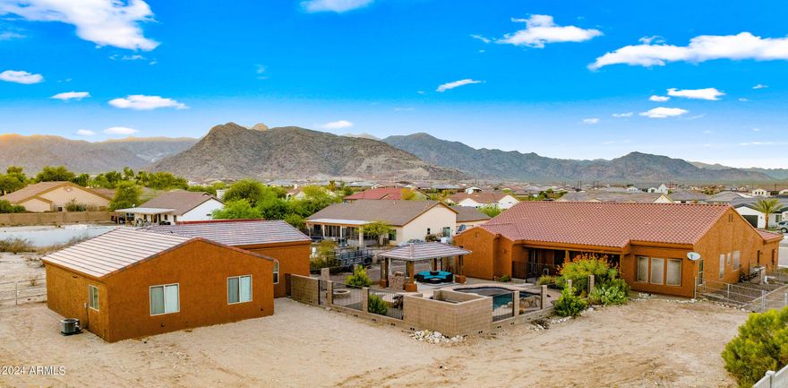TWO HOMES ON ONE PROPERTY | NO HOA | NEARLY 1 ACRE.  Rare opportunity to own a private Litchfield Park compound featuring TWO SEPARATE RESIDENCES on a fully fenced lot. Includes a 3,051 SF Custom Main Home AND a NEW 2024 High-End 920 SF ADU/Guest House.
The main residence offers 4 beds, 2.5 baths, den, & 14-ft vaulted ceilings. The 2-bed, 1-bath guest house is a modern masterpiece w/ full kitchen, tankless water heater, laundry, & 12-ft high garage (lift-ready!).  Total 5 garage spaces + massive RV/Trailer parking.
Outdoor Oasis: Sparkling pool w/ waterfall, spa, Baja step, & grand gazebo. Perfect for multi-gen living, rental income, or a home studio. An incredible value that cannot be built at this price! This estate offers the ultimate in versatility and privacy.