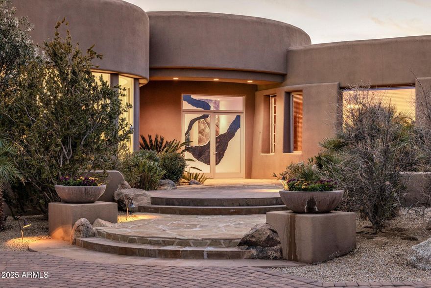 Most spectacular city lights and mountain views, within the prestigious Boulder Crest gated community. Custom built by Tierra, a blend of elegance and comfort. Inviting living room with striking stone fireplace, wall of pocket doors for inside-out living enjoyment, circular wet bar transitioning to open gourmet kitchen with wide island, ample cabinet space + walk-in pantry & wine room, open to family room and breakfast room, beautiful formal dining room full of natural light.  Very spacious primary suite w/ 2 generous walk-in closets & workout room + two en-suite bedrooms on the main level. Walking upstairs to additional guest bedroom with private bathroom & walk-in closet + loft/game room opening to a beautiful open patio with built-in firepit, perfect to contemplate the  scenic views and enjoy a relaxing evening with city lights and desert sunset. High quality finishes throughout such as travertine floors, Cantera stone, granite. Step out to your private oasis backyard with lush mature landscaping, negative edge pool, spa, stone firepit and built-in grill, fascinating boulder formations.
Just a few minutes to a number of hiking/biking trails, Troon North two renowned golf courses Monument and Pinnacle, Troon North resident private park with tennis courts and basketball.