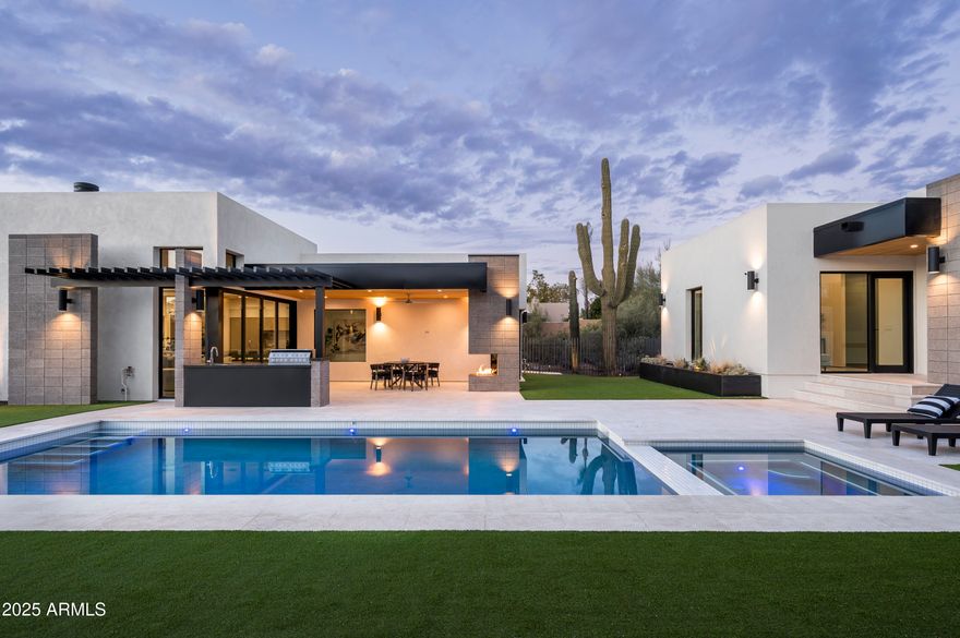 Nestled in the highly desirable executive community of Pinnacle Peak Shadows, this brand-new, custom-built residence is a true work of art. Located in the heart of North Scottsdale, just minutes from Scottsdale Airport, Scottsdale Quarter, Desert Ridge, and the charming towns of Carefree and Cave Creek, this stunning home offers luxury living at its finest.

Built in 2025 by Teran Developments, with architectural and interior design by Joel Contreras and Trent Hancock of Camelot Homes, this 3,501 sq. ft. masterpiece sits on a 20,038 sq. ft. lot. Every detail has been meticulously crafted, from the soaring 14' ceilings with White Oak plank T&G to the elegant stone countertops and custom cabinetry throughout.

The chef's kitchen is a true highlight, featuring soft-close Marfa custom Desert Oak cabinetry, a massive 12' waterfall island, and top-of-the-line Wolf and Sub-Zero appliances, including a 48" cooktop range, double oven, 36" fridge/freezer, and a 102-bottle wine fridge. Additional amenities include Brizo faucets, integrated Cove dishwashers, and a Wolf microwave drawer. The kitchen flows seamlessly into a spacious dining room and lounge, complete with a custom chandelier, bar island, and prep sink with waterfall stone edges, all enhanced by built-in surround sound.

The great room is the ultimate space for entertaining, offering a 15' opening with 10' custom sliding glass doors, 14' ceilings, and a dramatic exposed masonry gas fireplace. A stunning outdoor oasis awaits in the backyard, featuring a resort-style pool and spa, T&G White Oak covered patio, a cantilevered fireplace, outdoor kitchen, and raised steel planter beds.

This home boasts four luxurious en-suite bedrooms, including a private primary suite with sweeping pool and garden views, a custom floating vanity with marble countertops, a multi-head walk-in shower, and a freestanding stone bathtub. The walk-in closet is a designer's dream with custom California Closet design, dual islands, and a built-in shoe display wall.

The detached guest house suite is an impressive bonus, offering a full kitchen, washer/dryer, and private patio. Additional features include a dedicated office/study, temperature-controlled 3-car garage (expandable to 5), and pre-wiring for solar panels, car lifts, and electric car chargers.

With every modern convenience and a focus on design excellence, this home is a rare opportunity to experience the ultimate in desert luxury.