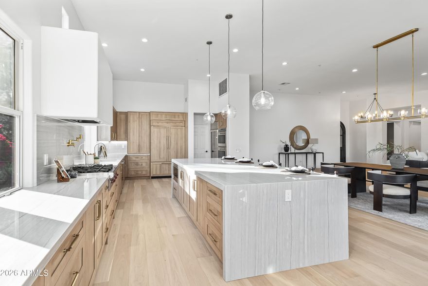 Located within the gated DC Ranch community, this newly renovated residence offers refined living with a modern open-concept design. The expansive great room seamlessly connects the dining area and chef's kitchen, featuring a fireplace and a dramatic wall of sliding glass doors that create effortless indoor-outdoor flow. The home also includes a private 1-bedroom, 1-bathroom casita—ideal for guests or multigenerational living. The kitchen is thoughtfully appointed with new custom wood cabinetry, high-end appliances including a wine refrigerator, multiple ovens, a gas cooktop, an oversized island, pantry, and a sunlit breakfast nook—perfect for both everyday living and entertaining. The primary suite is a private retreat, with separate sitting area, access to the backyard, and spa-inspired bathroom with a freestanding soaking tub, oversized walk-in shower, private water closet, and a custom-designed walk-in closet. Additional highlights include a dedicated office, the separate casita, and a 2-car garage. Outdoors, enjoy a custom-designed new pool, covered patio, and built-in BBQ stationan inviting setting for entertaining family and friends. Residents enjoy all that DC Ranch has to offer, including guard-gated security, multiple community centers, resort-style pools, fitness facilities, tennis courts, and an extensive network of walking, hiking, and biking trails. Just minutes from Market Street's dining and boutique shops, this home places North Scottsdale's premier amenities, world-class golf, top-rated schools, and a vibrant community lifestyle right at your doorstep.