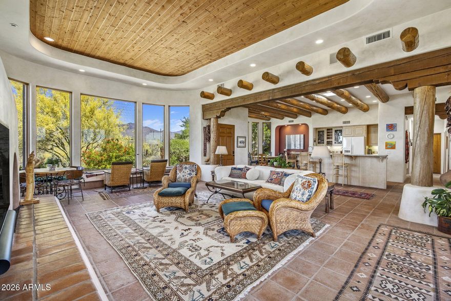 Tucked into the serene high desert of Carefree, this exceptional Santa Fe-style estate captures the essence of Arizona living with breathtaking, unobstructed mountain views in every direction. Set on an expansive 4.5-acre south-facing parcel, the property offers unmatched privacy along with both sun-filled days and stunning sunset views across the desert horizon. A long, welcoming driveway--lined with mature saguaros--creates a dramatic arrival experience, especially at night when the iconic cacti are beautifully illuminated, casting a warm desert glow. Just five minutes from the charming shops, dining, and amenities of Carefree Town Center, the home strikes a rare balance between seclusion and convenience. Designed and built by its original owners, the residence showcases timeless Santa Fe architecture with thoughtful custom details throughout. The 3-bedroom, 3.5-bathroom open-concept floor plan is designed for both comfort and effortless entertaining, with a spacious great room anchored by a cozy fireplace and seamless flow into the main living areas. High-quality windows and doors frame sweeping views while enhancing natural light and indoor-outdoor living. A beautifully manicured, walled front garden adds charm and privacy, creating a tranquil entry experience. Step outside to discover multiple patio spaces, each perfectly positioned to take in the surrounding scenery, along with an inviting outdoor fireplace ideal for enjoying Arizona's desert evenings year-round. The expansive grounds offer ample space to add a pool and spa, as well as the opportunity to build a detached guest house if desired. A standout feature is the fully functioning private well, providing both household and landscaping water--an invaluable asset that delivers sustainability and significant cost savings. This meticulously maintained, move-in ready home presents a rare opportunity to own a true desert retreat where authentic design, natural beauty, and modern livability come together in one extraordinary setting.