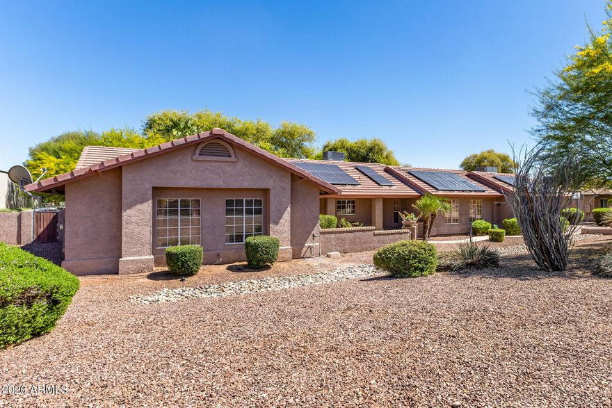 This single level home is situated on over  an acre of lush green grass, and trees with a sparkling fenced pool surrounded by palm trees - your own private oasis.. The home features open expansive living spaces with a living room, family room and an Arizona room, you have lots of options for formal or casual living.
The open kitchen is an inviting space to prep, cook and gather around the large island. Granite countertops, stainless steel appliances and plenty of cabinet space. 
There is room for all your toys or hobbies in the detached garages. 2 car garage in front and a single car garage in the rear of property that would be a perfect shop or maybe a great ''mancave'' /''she shed'' with both water and electric.
Grass is watered through flood irrigation 
Chickens and horses are welco
