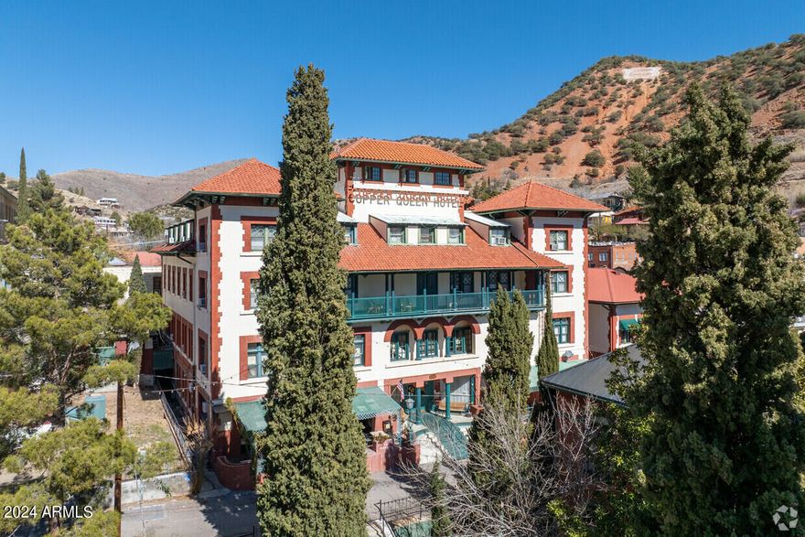 Don't miss out on this extraordinary opportunity to become the proud owner of Arizona's most storied hotel. The Copper Queen boasts a bar & restaurant and 48 meticulously remodeled rooms and suites, each appointed with private bathrooms.  Every space is adorned with period antiques, vibrant wallpaper, sumptuous curtains, and luxurious bedding, evoking the opulence of a bygone era. The hotel has undergone a meticulous restoration since 2017, preserving its heritage while integrating modern upgrades where necessary. As the largest hotel in Bisbee, boasting both a pool and an elevator, acquiring the Copper Queen represents not just a sound investment but a legacy of pride and distinction. Don't miss your chance to write the next chapter in this timeless tale and legacy of hospitality.