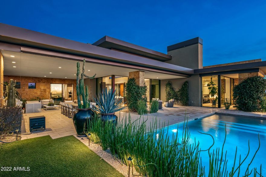 Fabulous desert contemporary home designed by renowned architect Ron Brissette. Floor to ceiling glass is everywhere captivating the majestic continental mountain views, city lights and sunsets. Giant corner retracting doors in the great room opens the entire house to the gorgeous backyard and covered patio area. Top of the line appliances, cabinetry, and finishes were selected to complete this home. Lutron low voltage one touch lighting controls and automated shades are included as well. Who is going to be the lucky one to call it home? Hurry. Won't last at this price. The light fixtures in the dining room, kitchen island and casita do not convey. Mirror in casita, architectural landscape spheres, fountain and planters do not convey.