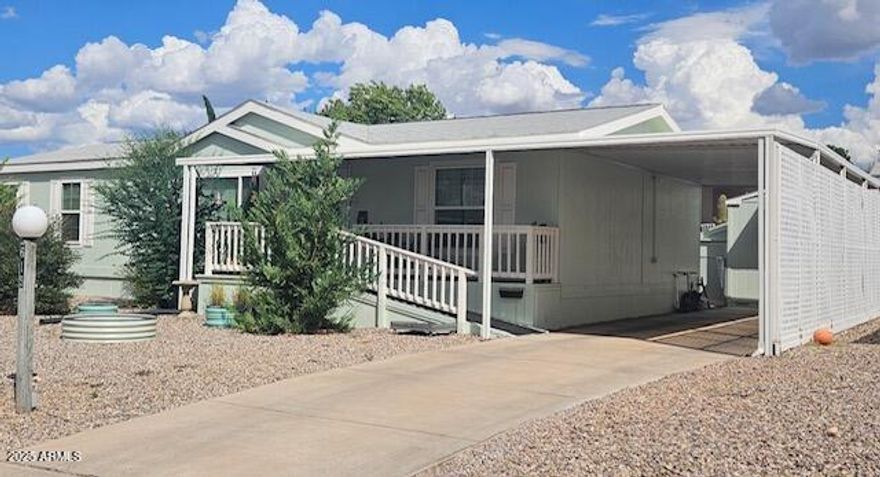 This lovely home offers that peaceful, easy feeling that we are all looking for!!! Very clean and well maintained. 3 bedroom, 2 bath. Large, comfortable rooms in this 1,512 square foot split floor plan home. Newer Laminate flooring, baseboards and interior paint through out home. Walk in pantry, utility room with additional space for a freezer or even more storage. Front (with Ramp) and rear covered decks. Premium, spacious lot with small area of chain link in back yard. Pum Crete (formed concrete panel) type skirting. Large shed with three nicely done additions. Easy care landscape using primarily the Xeriscape style. This really is a nice one! The park is gated and offers two club houses. Outdoor pool, indoor pool and spa. Welcome home!