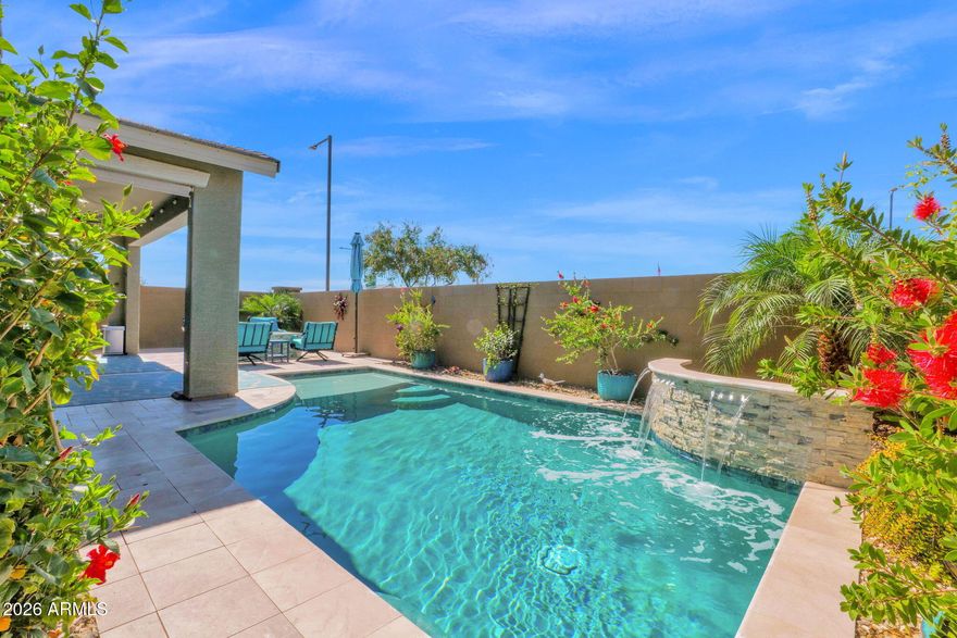 Why wait for new construction? This meticulously upgraded home is truly move-in ready--complete with over $80,000 in enhancements and modern smart-home features throughout.Step into your own private retreat: a resort-style backyard with a sparkling pool and waterfall, covered patio, firepit with seating area, and unobstructed mountain views. From here, you can even enjoy watching SpaceX launches streak across the sky, creating unforgettable evenings right from your own yard.
Inside, the open floorplan offers 4 bedrooms, 3 bathrooms, and a separate living space perfect for guests, multigenerational living, or a home office. The bright interior showcases wood-look tile flooring, designer paint, upgraded lighting, and a welcoming living room. The beautifully appointed kitchen features recessed and pendant lighting, granite countertops, subway tile backsplash, stainless steel appliances, crown-molded cabinetry, pantry, and an island with breakfast bar. Sliding glass doors in the great room create seamless indoor-outdoor living. The primary suite includes plush carpet, a walk-in closet, and an ensuite bathroom with a granite vanity. This home blends comfort, style, and thoughtful upgrades--inside and out.