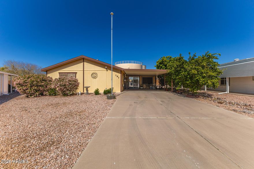 Discover this charming 3-bedroom manufactured home with beautiful mountain views! Inside, you'll find an inviting layout filled with natural light, showcasing soft carpeting underfoot, tile in all the right places, vaulted ceilings for a feeling of openness, and neutral colors. The spacious kitchen is complete with ample cabinetry, tile backsplash, granite countertops, an island, and built-in appliances for a seamless cooking experience. Get a good night's rest in the main bedroom, offering a closet with mirrored doors and a full bathroom with double sinks and a separate shower & tub. Inside laundry area for added convenience, with plenty of space for storage. Out back, you'll have a putting green, perfect for entertaining and relaxing evenings. THERE IS A ADDTIIONAL 1000 SQ FT SUN ROOM !!