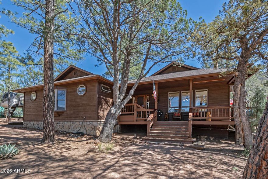 Wake up to Strawberry Mountain views, spend your evenings watching wildlife from a private deck overlooking national forest, and step directly onto hiking trails from your own backyard. This 1.1-acre horse property is the complete package--main home, guest house, 3-car garage, and direct forest access, all behind custom wrought iron gates on fully fenced grounds.

The main home draws you in with warm wood accents, a gas fireplace, and a wraparound deck made for entertaining. The primary suite features a bay window framing the mountain and a soaking tub en suite. A second bedroom with office area, spacious eat-in kitchen, covered front and back decks, and RV parking round out the main property.

The detached guest house--with its own driveway, fenced yard, porch, full kitchen, bedroom, bath--is ready for extended family, rental income, or a private retreat. A workshop garage, chicken coop/shed, newer roofs on all structures, and a new HVAC with A/C and attic fan complete the picture.