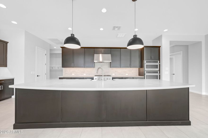 BRAND NEW 3336SF single level with 3 ensuite beds, an enclosed study, retreat, extensive backyard covered living area and split 3 car garage on 10,551SF homesite in 55+ Victory; open plan with huge energy efficient windows and 16' sliding glass door opening to extended covered patio; 10' ceilings and 8' doors; gourmet kitchen with GE Monogram appliances including 42'' Built-in refrigerator and gas rangetop;  large quartz island and gorgeous dark cabinets with custom tiled backsplash; quartz c-tops in all baths; upgraded tile, carpet and pad in all areas; 2-tone paint throughout; upper and lower cabs with sink in utility room; 2x6 construction and extensive new home warranty.