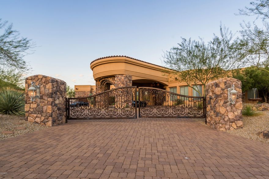 Showing by appointment. Privately gated, luxurious and meticulously maintained Tuscan estate settled on 3.3 acres. This Mountain Top property features two Master-Suites, split floor plan + 2 additional Jr suites and guest quarters! 12-seat movie theater wet bar, and state of the art kitchen with its very own Italian 750 bottle Wine Cellar. Step out to a Resort backyard with spectacular mountain with 365 degree unobstructed views, multiple pools, jacuzzi, Grotto waterfall, streams and outdoor kitchen/BBQ. It features: Over-sized windows, abundant natural light & remote control chandeliers! The Chef's kitchen boasts granite counter-tops, custom Alder cabinetry, dual dish-washers, Subzero fridge & Dacor appliances! Don't miss Air-conditioned 8 car garage. SEE MOTION VIDEO under PHOTOS