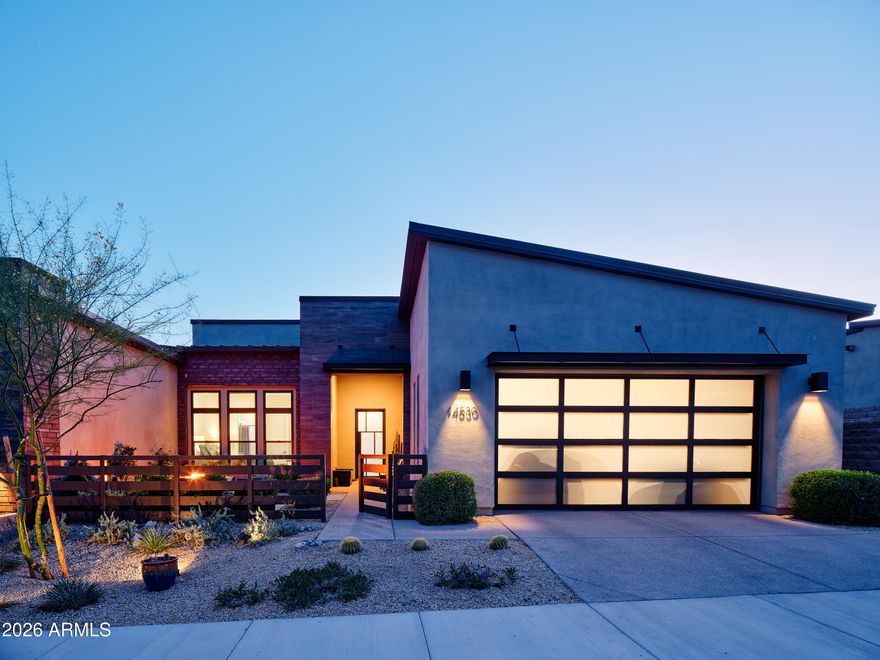 Spectacular elevated modern living at its finest with Views! Light and bright throughout with white cabinets. neutral palette throughout,1 level no steps. Designer finishes, chef's kitchen featuring quartz countertops, huge waterfall island,custom lighting and Wolf and Sub-Zero appliances with double ovens. High ceilings and expansive windows fill the home with natural light, while a 12' multi-slide door opens to seamless indoor-outdoor living with a spacious patio and sweeping views. A 72'' linear fireplace anchors the living area. Dual remote-controlled window treatments offer filtered or blackout light. The primary suite includes a freestanding soaking tub, walk-in shower, oversized closet, and north-side open space for added tranquility. Custom front Courtyard & so much more!