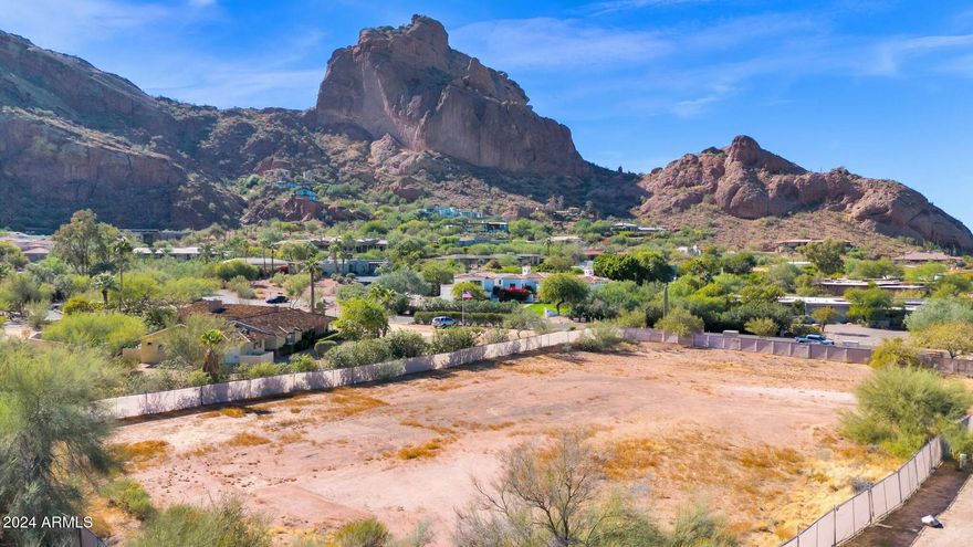 Another Candelaria designed Paradise Valley homesite, this one offers complete views of Camelback Mountain, Mummy Mountain, and Phoenix Mountain preserve on a flat one-acre parcel. Previously permitted, the Paradise Valley residence will comfortability perch at the base of Camelback Mountain and the sale will include full set of building plans, interior design plans and landscaping plans. The old structure was torn down, new home site prepped and fenced for you to see your incredible view home come together quickly, skipping years of planning. Sanctuary Resort, Paradise Valley Country Club, Mountain Shadows event center, Echo Canyon and PHX preserve hikes are all within a short walk. PHX International or Scottsdale Airports within 20min; simply convenient and stunning.