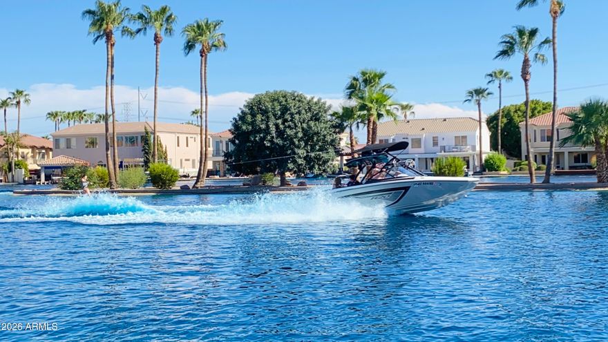 There are only 6 water skiing lakes in the entire Phoenix metro - 3 in Gilbert, 1 in San Tan Valley, and 2 in Buckeye. In the entire East Valley (Gilbert & San Tan), there is currently only ONE waterfront home available for sale, and it's this one in Playa del Rey Estates.

What also makes Playa del Rey so special is that it's the ONLY lake community here that truly allows a wide range of recreational activities. Most of the other lakes are primarily designed for tournament water skiing only. Here, residents can enjoy water skiing, jet skiing, boating, kayaking, paddleboarding, towable inflatables, boating up to 36 mph, and even catch-and-release fishing in the additional community lake. Beyond the lake lifestyle itself, the community is gated 24/7 and offers incredible amenities including a brand-new mini golf course with a fountain, clubhouse, basketball court, and floating dock. They also host community events year-round like Easter egg hunts, trick-or-treating, Christmas celebrations, and more.

As for the home itself, it's completely turnkey and was extensively remodeled between 2019-2020. It features a gorgeous gourmet kitchen designed for entertaining, beautifully renovated spa-inspired bathrooms, and even a luxury Savaria elevator for easy multi-level living. The automated stackable Pella sliding doors create seamless indoor-outdoor living and bring in an incredible amount of natural light.

The layout is also extremely functional and thoughtfully designed. There are two en-suite bedrooms -- one on each floor -- plus three additional bedrooms, a separate den, game and family rooms, formal living and dining spaces, and even a laundry chute. Combined with the high ceilings, spacious bedrooms, wide hallways, and overall flow of the home, it offers a perfect balance of comfort, privacy, and entertaining space.