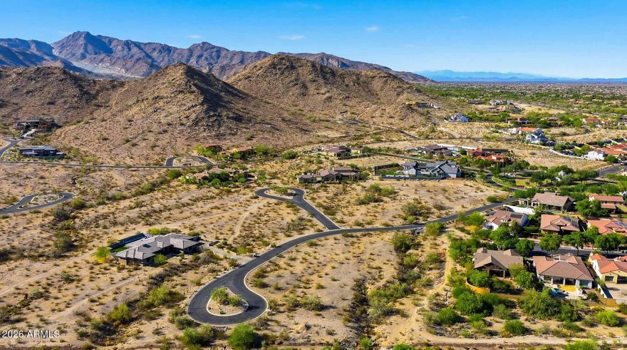 Exceptional 1.34-acre custom homesite in the coveted Mountain Coves Enclave of Verrado, featuring one of the largest building envelopes in the community. Privately positioned within a quiet cul-de-sac, this premium lot showcases breathtaking panoramic views of the White Tank Mountains, vibrant Arizona sunsets, and an unmatched sense of privacy and tranquility. Surrounded by the natural beauty of the Sonoran Desert, the expansive homesite offers the perfect canvas to design and build a one-of-a-kind luxury residence with ample space for resort-style outdoor living, pools, guest casitas, courtyards, and expansive entertaining areas. Ideally located near Verrado's premier amenities including championship golf, community pools, parks, fitness centers, top-rated schools, shopping, dining, and miles of scenic hiking and biking trails. A rare opportunity to secure one of the finest remaining custom homesites in one of Arizona's most sought-after master-planned communities.