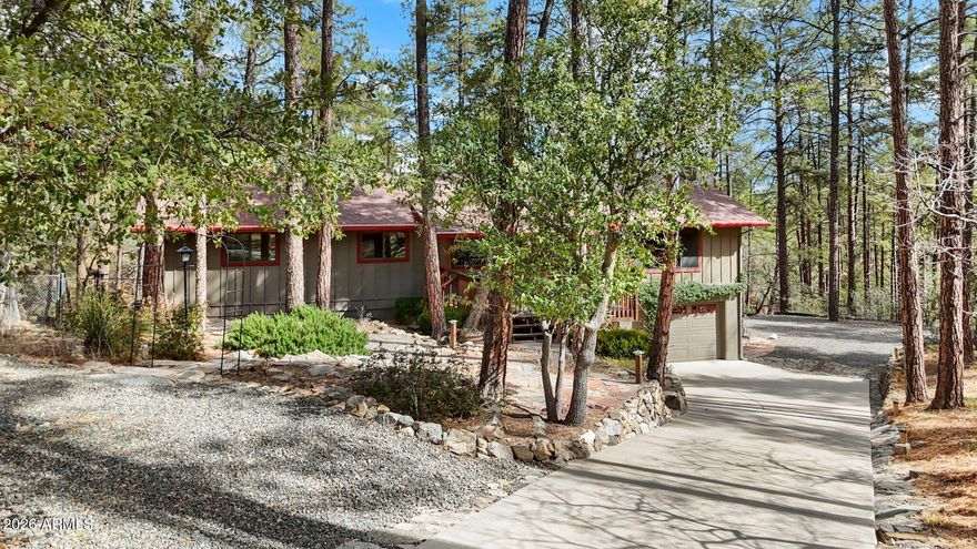Set on a rare 1.4 acre Ponderosa Pine covered lot with a seasonal creek in the highly sought-after Highland Pines community, this property feels like a private escape, yet remains just minutes from downtown Prescott. With hiking, biking, and ATV trails right outside your door, adventure and tranquility coexist!

Inside, timeless mountain architecture shines with expansive tongue-and-groove ceilings, warm wood flooring, and a striking stone fireplace anchoring the great room. Walls of windows frame peaceful forest views and flood the home with natural light, creating seamless indoor-outdoor living. In addition to the 4-bedrooms, this home features a flexible living space downstairs, that is currently used as a rec room but could be ideal for guests, a home office, or creative pursuits. A detached outbuilding - originally an oversized two-car garage -offers amazing potential as a guest house, home office, yoga studio, rental opportunity, or workshop, adding flexibility, future value, and possible income. RV parking further expands the property's functionality.

Enjoy covered front and back decks designed for year-round outdoor living, from crisp mornings to cool summer evenings. Offering privacy, usable acreage, and a true retreat-like setting, this is a rare opportunity for a full-time residence or part-time escape in one of Prescott's most treasured mountain communities.