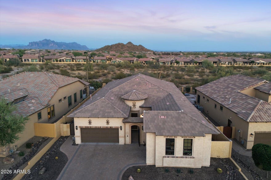 When location, privacy, and serenity matter, this exceptional home in the gated community of Mountain Bridge delivers. Framed by breathtaking mountain views and backing to an expansive private wash, the setting offers stunning sunsets and star-filled nights. Designed for both comfort and versatility, the flexible floor plan features 4 ensuite bedrooms and 4.5 baths, along with a dedicated dining/flex space, family/game room, and a separate living area--ideal for a variety of lifestyles. A sliding wall of glass seamlessly extends the living space outdoors, creating a true indoor-outdoor experience.
Enjoy your own private retreat with a sparkling pool and pergola, perfect for relaxing or entertaining. The chef's kitchen is thoughtfully appointed with a gas cooktop, large island, and abundan workspace and storage. Fresh paint and new carpet in the front guest rooms (2026). Additional highlights include a 3-car garage with a 4-foot extended-width single bay--ideal for storage or recreational vehicles.
Soaring 12-foot ceilings and an elegant vintage-style elevation enhance the home's light-filled interior, creating a warm and welcoming ambiance throughout. Thoughtfully designed and beautifully situated, this home offers a rare opportunity to enjoy comfort, privacy, and the best of Arizona living--ready to be experienced and enjoyed.
When you experience Mountain Bridge, you have Arizona resort style living at its finest. Community amenities (included in HOA): Pool, Tennis, Pickleball, Basketball, Fitness Center, Playground, Clubhouse, Walking and Biking Trails and more. Fantastic location surrounded by Great Schools, Restaurants and Shopping. Minutes to Usury Mountain Park, just 5 mins to Freeway, 15 minutes to Saguaro Lake, 20 Minutes to Sky Harbor Airport and Scottsdale.