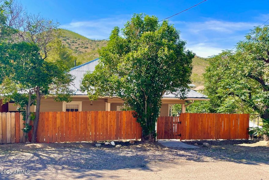 Bisbee bungalow in great condition offers so much for the discriminating buyer! The delight of this home is expressed in the open floor plan, private baths and walk-in closets in BOTH bedrooms, driveway for off-street parking, beautiful mountain views, and vacant lots on both sides for additional privacy (one of which is included in the sale!). From the gorgeous maple and Douglas fir floors, original beadboard ceilings and wainscoting to the wraparound covered deck, this lovely home is oozing with charm yet has had so much of the essentials renewed: Dual pane windows/doors, central a/c and heat, newer full-size washer and dryer, and newer plumbing and electrical. You will not want to miss this home! Buyer to verify all facts/figures.