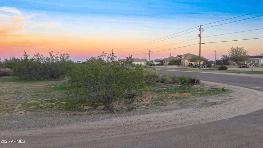 Escape the city and build your dream on this exceptional 8.82-acre CORNER lot in Maricopa's Hidden Valley! Perfectly positioned on on a corner lot, this premier parcel boasts rare and valuable features. Easy paved road access along the lot's entire southern boundary on Pampas Grass Rd, which also offers electricity at the street ready for connection. The western boundary along Ralston Rd is also paved for approximately 200 ft, providing outstanding access. With flexible GR (General Rural) zoning, no HOA, and breathtaking 360-degree mountain views, the possibilities are endless. This is the perfect blank canvas to build a custom dream home, set up a manufactured home, bring your horses, or create a private desert compound!