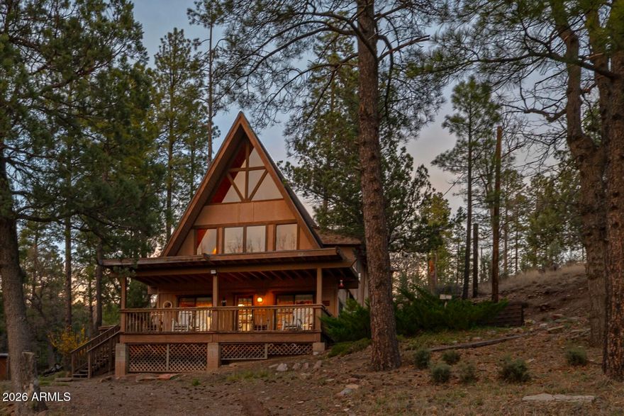 Welcome to your peaceful retreat in Ponderosa Springs! This charming three-level cabin nestled in the woods offers three bedrooms and two bathrooms, perfectly blending rustic warmth with comfortable living. The main level boasts soaring vaulted ceilings, abundant natural light from large windows, and beautiful tongue-and-groove knotty pine throughout. Highlights include a cozy pellet stove, an open-concept family/living room flowing into the kitchen with eat-in dining and breakfast bar, a spacious primary bedroom, a full bathroom and a convenient walk-in pantry. A large storage room with cabinetry provides ample space for organization. A custom wooden spiral staircase leads to the second level, featuring large windows, a propane gas heating stove, a fun bunk room for the kids/teens, a second family/living area, a full bathroom, and a laundry/mud room. Another spiral staircase ascends to the private loft bedroom with privacy drapes. Every level offers stunning forest views. Outside, enjoy a covered front porch, one acre + of serene, private wooded land, and two large sheds for extra storage - located near the Rim Lakes in Unit 23 where temperatures are always 30 degrees cooler than the Valley. Privately sourced well water enhances the property's self-sufficient, cabin lifestyle. Whether you're looking for a cozy Arizona A-frame cabin for the whole family or a serene getaway to create lifelong memories, this is the one!