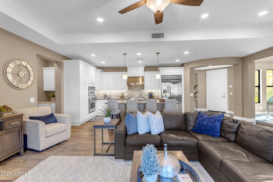 Welcome to Serenity Shores at Fulton Ranch, where luxury meets effortless living. Prepare to be amazed. This highly sought-after, ground-floor, single-level & former MODEL Villa showcases richly appointed finishes at every turn. The gorgeous gourmet kitchen is a true showpiece, featuring a gas cooktop w/a designer hood vent, striking custom backsplash, slide-out cabinetry, & premium GE Monogram appliances. An inviting & spacious great room w/ multi-slider patio doors opens seamlessly to the outdoors & lake. The split floor plan offers three bedrooms plus a flexible dining room that can easily transform into an office or den. The luxurious primary suite includes a spa-like super shower & direct patio access. The guest bathroom offers an enclosed soaking tub/shower combo & dual sink vanity. Some other great features included in this gently lived in home are iron security doors, water softener & filtration system, beautiful flooring, custom drapery, north/south exposure, & attached 2 car garage. Relax or entertain on your private waterfront covered patio or take a short stroll to enjoy the many luxury amenities such as an outdoor living room w/gas fireplace, barbecue grills, resort style heated pool & spa, fitness center, & a beautiful clubhouse. You're just minutes from Snedigar Recreation Center & Dog Park, World-Class Golf, Walking Trails, Exceptional Dining, Local Shopping, Chandler Fashion Center, Intel/Price Tech Corridor, 101 & 202 Highway Access & Top Rate Schools. Experience the best of the best- elegance, convenience, & true Serenity. Whether seasonal or full-time, this maintenance free, gated community is perfect for a lock & go lifestyle. This is the home you've been waiting for!