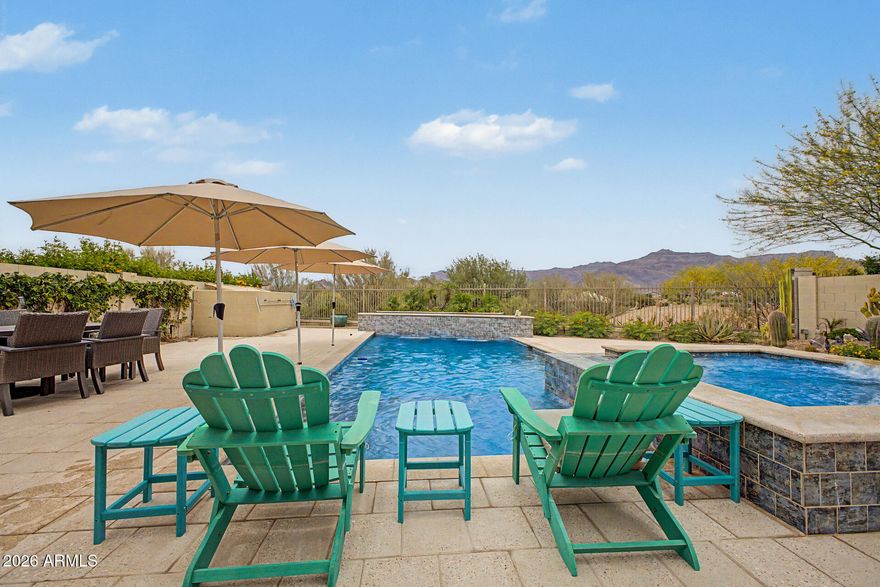 Stunning upgraded Gehan home with breathtaking Superstition Mountain views! This beautifully maintained 2,121 sq. ft. residence offers 3 split bedrooms, 3 baths, a 3 car split garage, and a versatile floor plan designed for comfortable Arizona living. Situated on an 8,320 sq. ft. lot, the property showcases exceptional curb appeal and extensive owner upgrades totaling nearly $200,000. The resort-style backyard is an entertainer's dream featuring a custom pool w/baha shelf, expansive decking, misting system, professional landscaping, paver enhancements, and a premium aluminum pergola with adjustable louvers for sun or shade.
Inside, you'll find 8' interior doors, custom closet systems, upgraded window shades throughout reverse osmosis, water softener, and thoughtful designer touches.  Energy-conscious buyers will appreciate the owned solar system. Car enthusiasts, hobbyists, or those seeking additional workspace will love the epoxy-coated garages equipped with mini-split climate control systems. The kitchen features 42" uppers, a 5 burner gas stove-top plus a wall oven and built in microwave.  This home is being sold furnished so all you need to do is bring your personal items.  

Located in one of Gold Canyon's most desirable communities, this home offers the perfect blend of luxury, comfort, and stunning desert scenery, all just minutes from hiking, golf, and outdoor recreation.