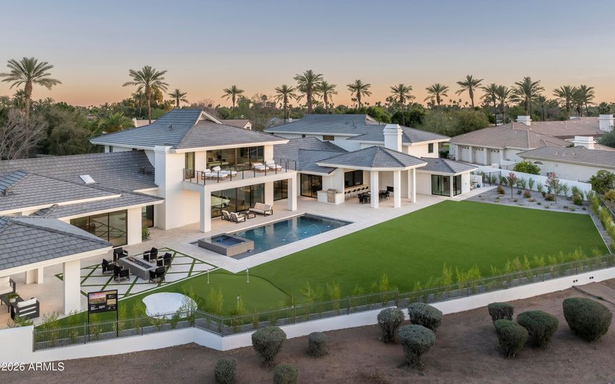 Welcome home to Vaquero Dr at Gainey Ranch, a prestigious gated enclave offering lush surroundings, championship golf, resort-style amenities, and exceptional location convenience. Perfectly situated along the Arroyo golf course on a near 1 acre lot, this remarkable estate captures sweeping golf course and Mummy Mountain views while being just minutes from upscale shopping, dining, the Loop 101, and SDL & PHX Airports.
Designed for refined living and entertaining, the home includes an attached guest house with 2-3 bedrooms, living room, full kitchen and bar, private laundry, and a dedicated movie theater--ideal for guests or multigenerational living. The primary suite is a luxurious retreat featuring a private balcony with breathtaking views, drop-down ceiling TV, coffee bar, oversized steam shower, freestanding soaking tub, makeup vanity, and custom his-and-hers designer walk-in closets with washer and dryer, all serviced by an elevator.
Entertain effortlessly in the elegant great room with fireplace, dry bar, and dramatic 24-foot sliding doors. Additional highlights include a glass-enclosed wine room for over 350 bottles, a private study/office with custom built-ins, and a game/teen room with full wet bar opening to the backyard. 3 en-suite bedrooms provide comfort and privacy, while a private gym and spa offer a sauna, cold plunge, outdoor shower, and patio access.
The resort-style backyard features a brand new pool w/ zero-edge spa, covered outdoor dining with fireplace, BBQ area, fire pit, ramada, putting green, and expansive turf. A gated motor court and 6-8 car garage complete this exceptional Gainey Ranch estate, enhanced by a discreet whole-home automation and AV system for seamless modern living.
Golf memberships available.