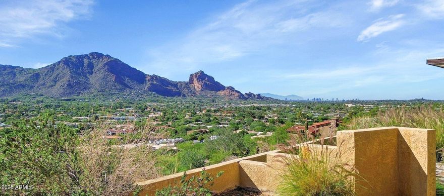 An exceptional opportunity awaits on this exclusive 3.88-acre premium view lot—a rare combination of privacy, space, and unparalleled views. Perched in a serene hillside setting surrounded by natural desert beauty, this property features a flat building pad offering endless possibilities to remodel the existing residence or create your dream estate from the ground up. Enjoy breathtaking panoramic views of Camelback Mountain, the sparkling city lights, and sweeping valley scenery from sunrise to sunset. This is a truly special homesite—a private retreat that captures the essence of luxury desert living, blending tranquility, prestige, and awe-inspiring scenery in one remarkable setting.