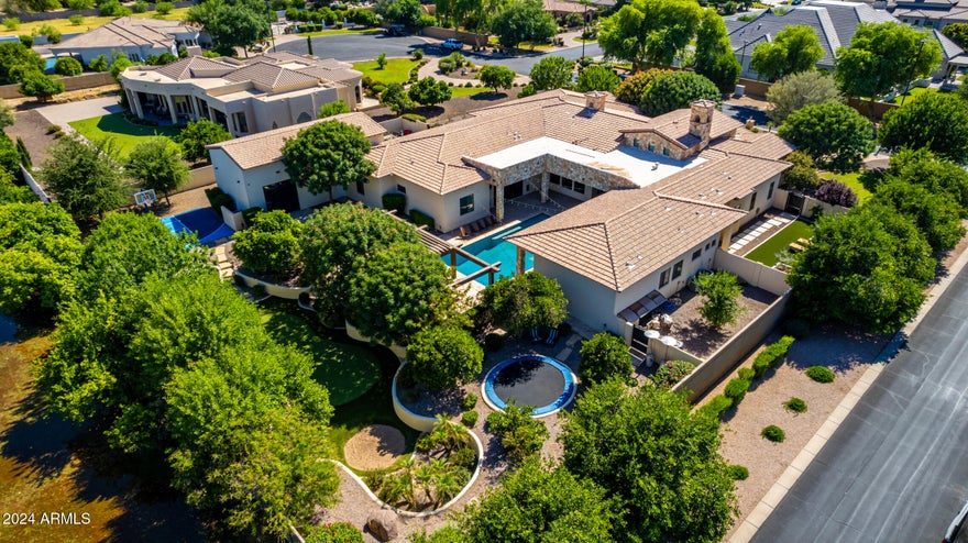 **Willing to offer seller financing!**

Stunning custom home in one of Gilbert's finest neighborhoods. Perfect floor plan w/custom built in cabinetry throughout. This home has been meticulously cared for, with the dream backyard! Equipped with Control 4 system w/security cameras & built in speakers inside & out. Impressive storage space throughout w/ space to entertain & host guests in the D. Casita w/ full kitchenette. Soaring tall ceilings in every room with gorgeous crown molding.  Large bedrooms, all w/ walk-in closets and en-suite bthrms. 
   
The backyard is a child's paradise with the 10 ft deep heated pool, drinking fountain, misters, in-ground trampoline, basketball court, sunken fire pit area, golf course, multiple orange trees, lemon & grapefruit & built in grill. And there's room for all your toys in the climate controlled RV garage/entertainment facility.  Conveniently located minutes from Gilbert Regional Park, San Tan shopping, and in award winning Chandler school district.  Don't miss this dream home!