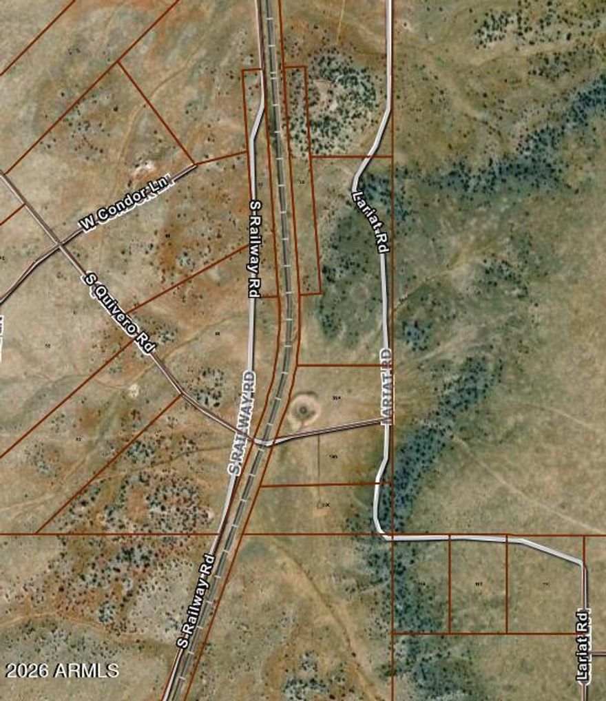 Incredible 14.88-acre parcel offering endless possibilities in a peaceful rural setting. This unique property borders State Land and the Grand Canyon Railway, creating a scenic backdrop with added privacy. A natural cattle pond attracts abundant wildlife, making it ideal for nature lovers and outdoor enthusiasts. Located less than one mile off Highway 64, the property is accessed by a gated gravel road maintained by the HOA. Centrally positioned approximately 25 minutes from the Grand Canyon entrance and about 30 minutes from downtown Williams, this parcel combines convenience with tranquility. A recent perc test confirms eligibility for a standard septic system, making it ready for your future build.