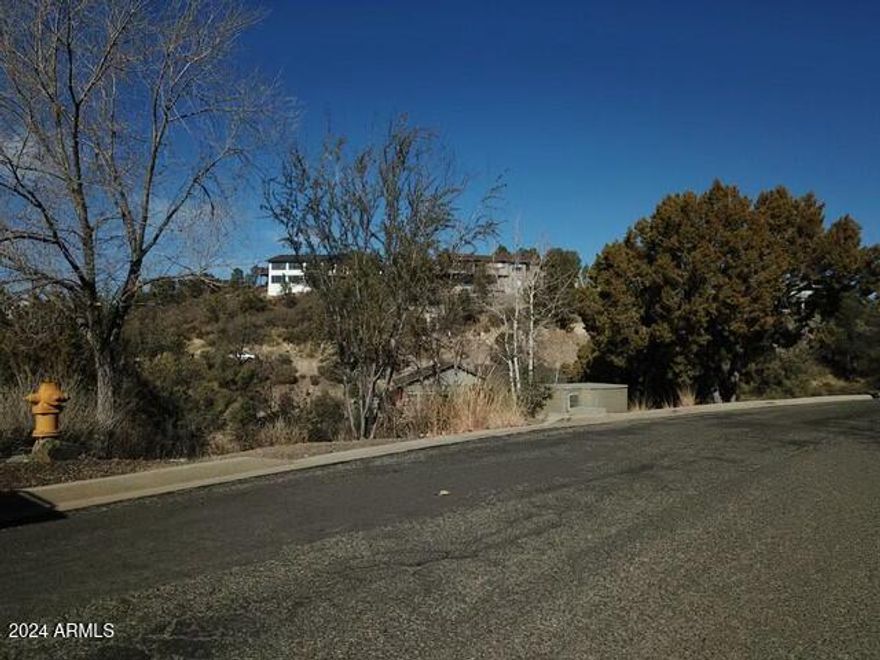 Scenic 0.49-Acre Lot in Prescott ideal for your dream home with mountain views. Discover the perfect canvas for your future home on this almost half an acre vacant lot, just minutes from downtown Prescott. Tucked away among mature trees this sloped lot offers stunning mountain views and abundant natural beauty, providing an ideal setting for building your custom tucked away residence in Northern Arizona! The unique topography of this property is perfectly suited for a walkout basement, offering both practical advantages and a seamless connection to the surrounding nature. With the convenience of being close to Prescott's historic downtown, shopping, dining, and outdoor activities are right at your doorstep, while still enjoying the peace and privacy of a wooded mountain-view retreat.