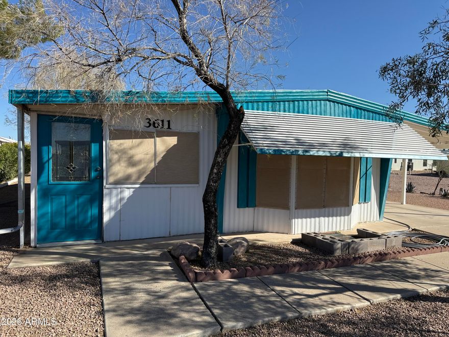 This is a 2 bedroom, 2 bath home that has an Arizona room, possibly as much as 300 sg ft of additional living space.  (not added into the square footage) for nice area to entertain or hobby room.  New wood laminate flooring in the living room,.  New tile tub and shower in the primary bedroom.  New carpeting in the Primary Bedroom.  New Birchwood paneling in the primary bedroom.  Both Bathrooms are fully remodel.  Built in China hutch in living room.  The Arizona Room has a new roof, as well as a large portion of the main house done in January 2026.  This is a cute lot and a wonderful subdivision where you own the land, low HOA fees for lots of fun activities: golf, heated pools, spas, pickle ball courts, horseshoes, billiards hall, clubhouse with craft rooms, exercise area and Library.