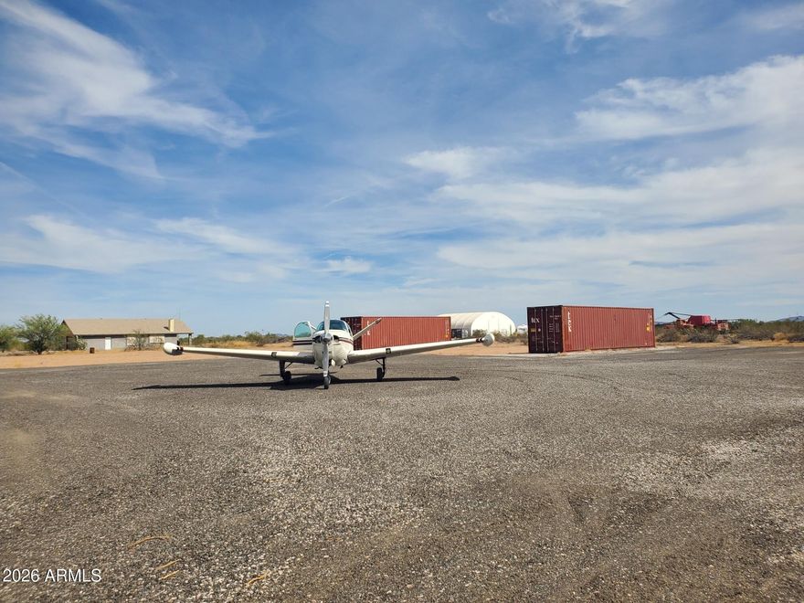Rare opportunity to acquire a 10-acre aviation property in a developing Arizona airpark, featuring direct primitive taxiway access in close proximity to the threshold of a 5,000-foot private runway (0AZ1) and a hangar shell currently under construction--ready for buyer completion. This parcel is surveyed complete and can be divisible into four (4) 2.5-acre airpark lots, offering flexibility to create a private aviation estate, a pilot enclave, or a small airpark development. The property is located approximately 300 feet from the runway, consistent with many established airparks. The airpark is in an early-stage development phase, providing buyers the advantage of early access and long-term upside. CCRs are forthcoming and expected to support residential aviation use for homes and hangars. The hangar has been started, allowing the buyer to complete and configure it to suit personal preferences-saving time and initial site planning versus raw land.  Early stage airpark with long term upside!  Cash friendly transaction. Separate from sale, there is a lightly used tractor, flat bed trailer and other equipment to facilitate DIY grading, material moving, hauling, etc.  Water source within 500 feet.