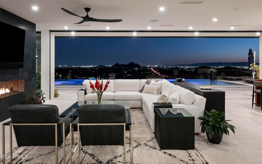 This steel beam, glass and wood contemporary masterpiece, completed in July 2023 by Tiara Sun Development, sits on a sprawling 38,550 sq. ft. lot on a private street on the south slope of Camelback Mountain. Boasting 6,982 sq. ft. of luxurious living space, the home offers breathtaking city views framed by Camelback Mountain as a stunning backdrop. The property includes three en-suite bedrooms, a separate art studio, a media room/theater, a gym, and a bar/billiard room. 
The chef's kitchen is a true showstopper, featuring Burdette custom walnut cabinetry, a 12-foot Quartzite and walnut waterfall island, a Wolf 48'' cooktop range with dual ovens and six burners, Built-in wall Wolf Ovens, Sub-Zero refrigerators and freezers, two Cove integrated dishwashers, a Wolf microwave, and a reverse osmosis drinking water system. 
The open-concept design is enhanced by custom floor-to-ceiling sliding doors, Italian porcelain flooring, and a butler's pantry. The luxurious primary suite showcases walnut hardwood flooring, floor-to-ceiling windows with automated shades, an electric fireplace, built-in speakers, and 180-degree city views. The suite also offers a 65" drop-down TV, his and hers custom walk-in closets with shoe displays, and a master bathroom with floating Burdette cabinets, quartzite countertops, Brizo faucets, multi-head walk-in shower, freestanding tub, Toto washlet, and more. 
The resort-style backyard is designed for relaxation and entertaining with a 50' wet/infinity-edge pool, built-in spa, custom putting green, a Wolf barbecue island with a Sub-Zero beverage fridge, and an outdoor TV with built-in speakers. 
Additional features include a four-car garage with 11-foot ceilings, epoxy floors, electric car charging and pre-wired for solar panels. The home is built with a steel I-beam structure and foam insulation between floors for sound control. The smart home system, Control 4, offers seamless automation throughout. 
Located just minutes from downtown Phoenix, Scottsdale, and upscale shopping and dining, with easy access to Sky Harbor International Airport, this home offers the perfect blend of luxury, privacy, and convenience.