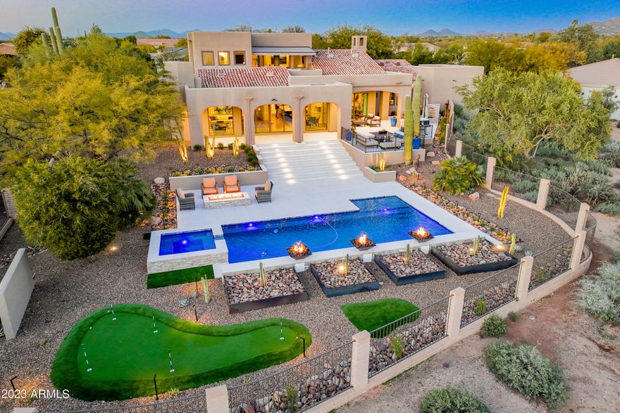 Stunning estate situated perfectly on a private 1+ acre N/S lot bordering NAOS and offering spectacular mountain & city views. This spacious 5 bed/4 bath home (+ loft & 3 car garage) has been completely & thoughtfully renovated and boasts high end upgrades throughout. It features a popular open & split floor plan, gorgeous curb appeal and a jaw-dropping resort-style backyard (completed Dec 2022). The great room offers a spacious & inviting family room w/ a wood-burning fireplace and expansive south facing windows that provide an abundance of natural light & breathtaking views. Remodeled by Affinity Kitchen Designs the open concept kitchen boasts high end custom wood cabinetry w/ pull out shelving and quartzite countertops, convenient breakfast bar, Pentair water filtration system, and state of the art appliances including a 6 burner Wolf gas range, dual ovens & hood, and Sub Zero refrigerator w/ wine fridge. The primary suite boasts a cozy electric fireplace, his & her separate vanities and large walk-in closets w/ wet bar, soaking tub, walk-in shower w/ dual shower heads, convenient outdoor shower, plus back patio access w/ serene waterfall feature. Adjacent to the primary suite is an ideal office/den or bedroom with en suite bathroom. The other main level bedroom is ideal for guests as it's split from the primary bedroom & office/den and offers an upgraded ensuite bathroom w/ walk-in closet. The second floor offers 2 additional bedrooms with a jack & jill upgraded ensuite bathroom as well as a spacious yet cozy loft that includes a wet bar, large storage space plus balcony access where you'll enjoy endless sunrise & sunset views. The secluded backyard oasis is an entertainer's dream! It features an extensive covered & uncovered patio with multiple sitting areas, pristine porcelain tile, inviting fire pit, oversized sparkling pebble-tec pool w/ Baja step & aesthetic waterfall & fire features, new Pentair pumps and heater, large jetted spa, putting green and premium DCS 48" BBQ w/ bar top seating. Additional details include: 3 car side-entry garage w/ new Guardian epoxy flooring, Wifi MyQ door openers for new insulated aluminum and black glass garage doors, built-in storage cabinets & closet (abundance of storage throughout the home), large circle driveway, water softener & R/O system, new motorized awning w/ LED lighting over view deck, new exterior lighting, new iron front door, LED lighting throughout including back patio stairway, new tankless Navien water heater, Nest thermostats, Control 4 system, and RV gate. This home was carefully designed and has been meticulously maintained - true pride of ownership and will not disappoint.

This enclave of 28 luxury homes on a serene cul-de-sac street with no HOA offers convenient access to all Scottsdale has to offer - golf courses & country clubs (Troon, Pinnacle Peak, DC Ranch & Silverleak, etc), world-class resorts (Princess, Boulders, Four Seasons, etc), highly coveted restaurants & shopping (Kierland & Scottsdale Quarter, DC Marketplace, Grayhawk, etc), countless hiking trails, top schools, and so much more. Don't miss the special opportunity to tour (and purchase) this one of a kind property. Please note: most furniture is available on a separate bill of sale.