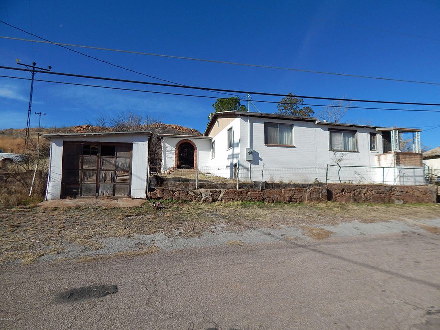 Priced to Sell!! With 2 parcels totaling .25 acres appx. this 3-bedroom 3/4 bathroom home has 1849 sq. ft under roof with a 160 sq. ft Arizona Room included. The kitchen is spacious and has 2 pass-throughs for your convenience. Just think about this: the beautiful porch/patio with Southwest inspired brick arches, is the perfect place for morning coffee as you plan your next project. After a long day, just relaxing would also be perfect. This home will DEFINITELY take some work, but it is priced right.  Parcel #'s are 102-05-055 and 102-05-056B.  The 2 vehicles are NOT included.