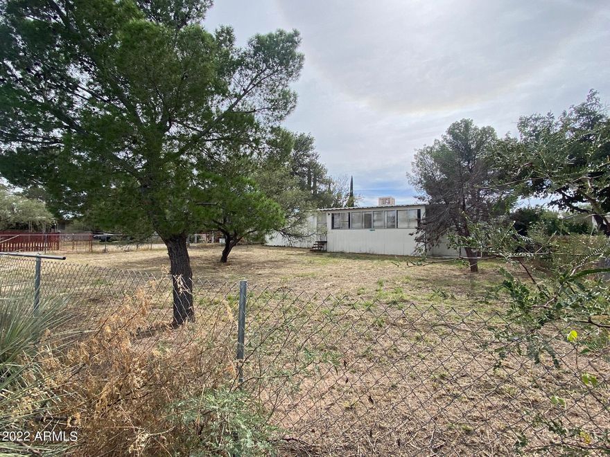 The home is located in a great neighborhood, on a paved road and a large fully fenced lot!!! 
You'll be close to Vail/Tucson. Benson... and only about 30 min from Huachuca City and Sierra Vista. 
This home is a fixer upper and is being sold as is where is-- Seller will not do any repairs.
Check it out today!!