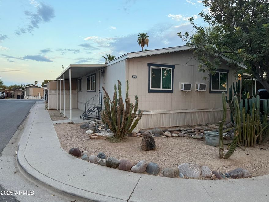 This charming double-wide home features an open-concept layout with a spacious living area perfect for gatherings. The kitchen has been upgraded with dark brown cabinets and new flooring flows throughout the home for a fresh, modern look. Outside, a convenient storage unit provides extra space for your belongings. Enjoy the community's peaceful atmosphere and amenities, including a clubhouse, pool, spa, game room, and laundry facilities. A perfect blend of style, comfort, and convenience!