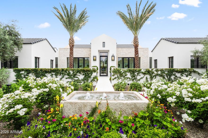 Set on nearly 2 acres with Mummy Mountain views, this Paradise Valley estate offers 20,000+ sq ft plus 6,000 sq ft of garage for 18 cars plus lifts. Designed by Candelaria Design and built by Arcadia Custom Builders, with recently completed phase two design by Katie Bowe Design. Interior features include white oak floors, rift oak cabinetry, Sierra Pacific windows/doors, chef's kitchen, prep kitchen/butler's pantry, and dual 432-bottle wine walls. Control4 automation, whole-home audio, and gated entry with cameras. Lower level includes 10' ceilings, lounge/bar, theater, salon/spa with sauna, massage room, shooting range, safe room, and indoor recreation space, including go kart track and playground. Additional highlights: mezzanine office, fitness studio, and children's retreat. Resort-style grounds with pool, spa, sprawling lawn and a ramada with outdoor full kitchen, pizza oven, grill, smoker, bar, and misting system. A detached guest house with dual suites, full kitchen, and laundry, plus a separate studio casita, provide ample accommodations and completing this one-of-a-kind offering.